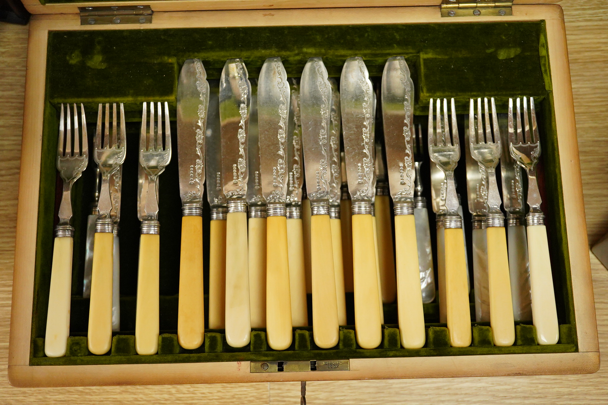 A set of six late Victorian bone handled fish knives and forks and a set of twelve mother of pearl handled dessert knives and forks, mahogany cased